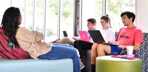 Students lounging and studying on colorful furniture