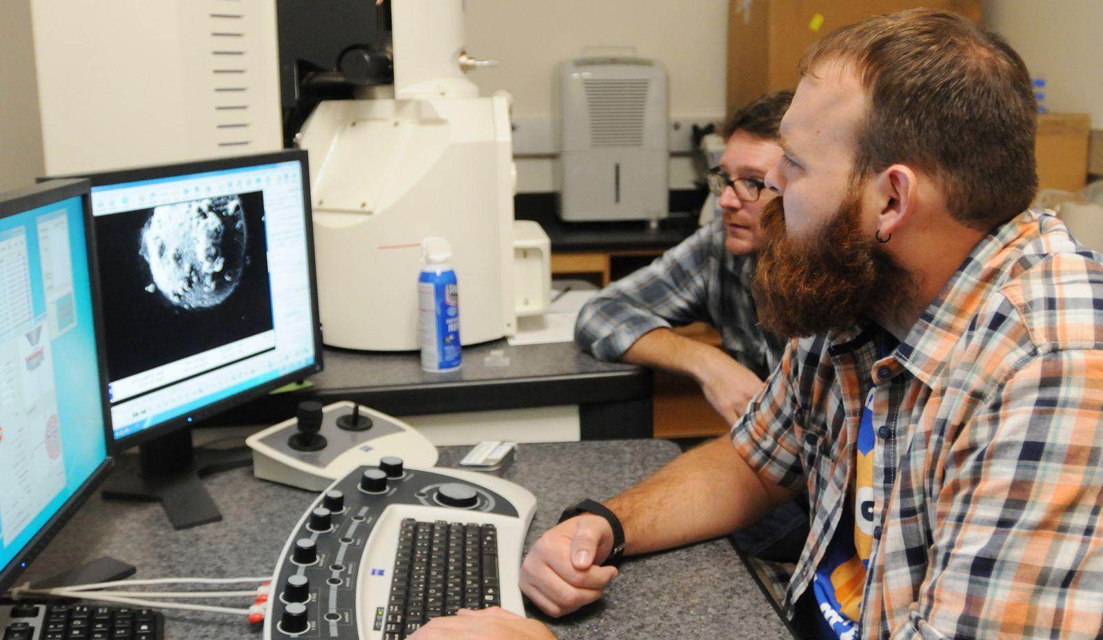 Students reviewing footage on a computer